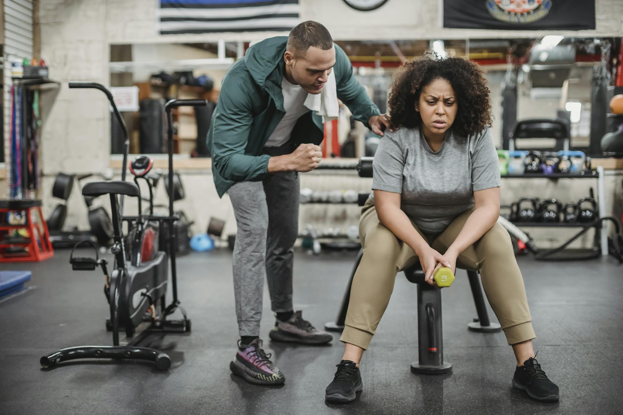 About A Personal Trainer Motivates A Woman During