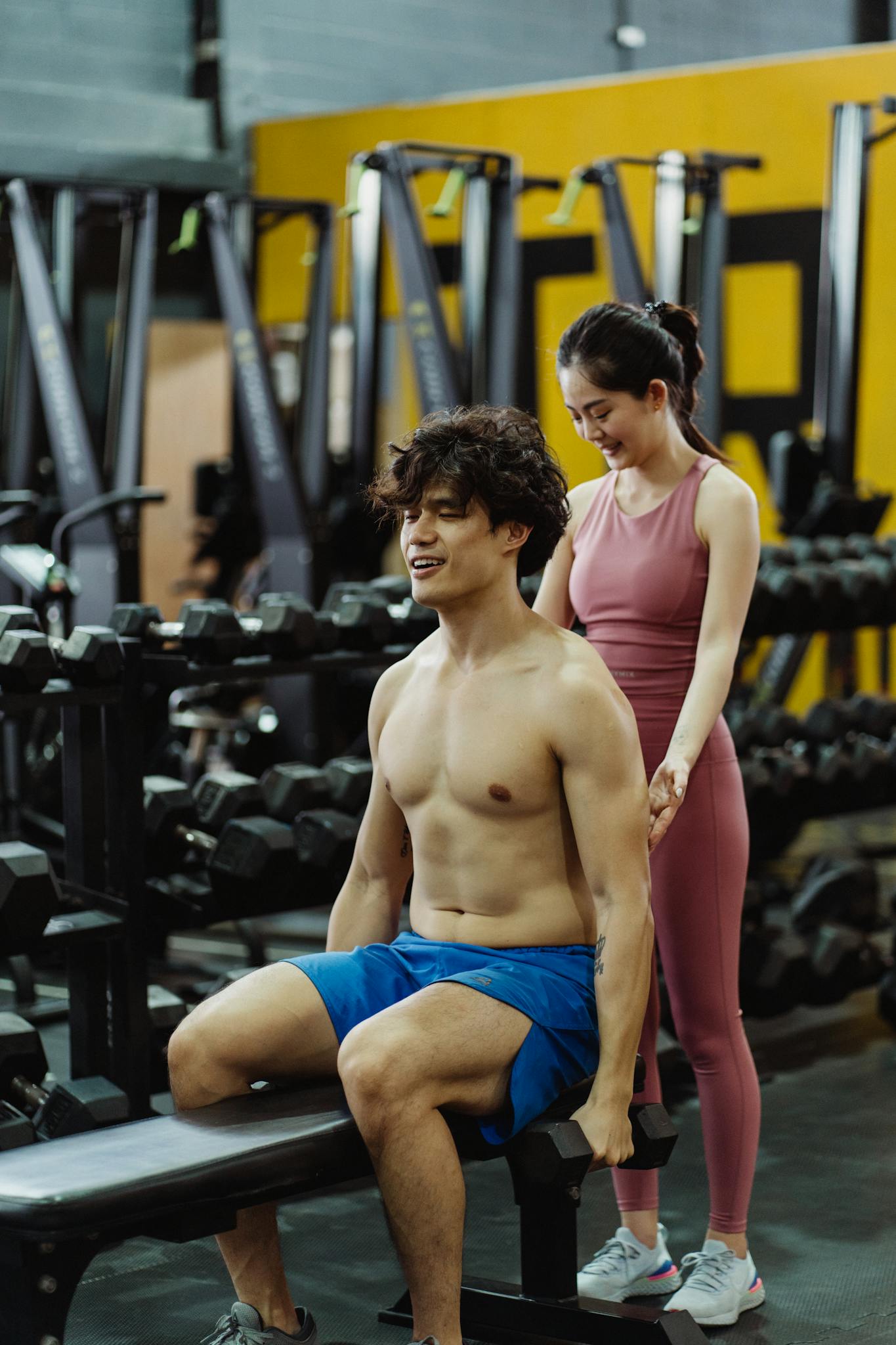Maximizing Your Blog’s Reach: SEO Tips for Bloggers Man and woman in a gym engaged in a personal training session, focusing on fitness and health.