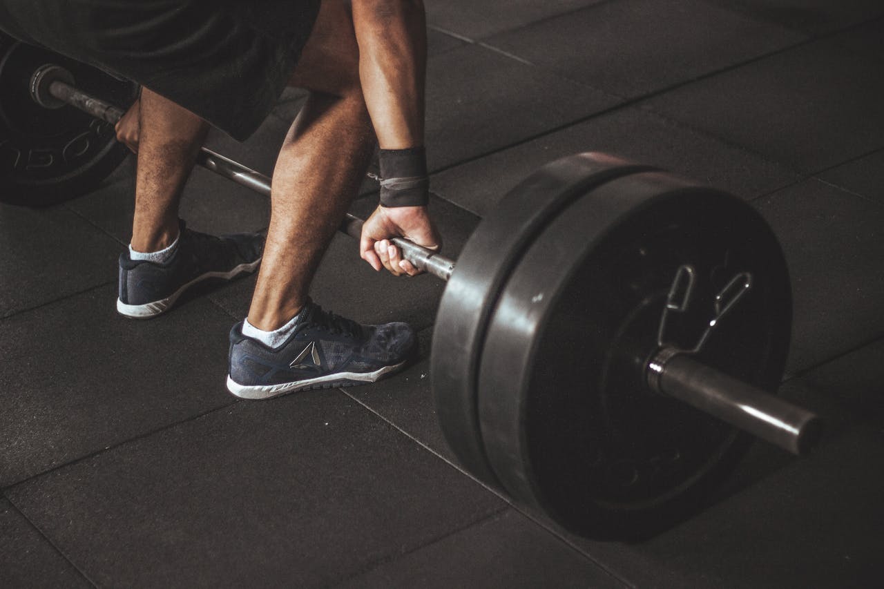 The Art of Drawing Readers In: Your attractive post title goes here A man lifting a heavy barbell during a gym workout, showcasing strength and fitness.