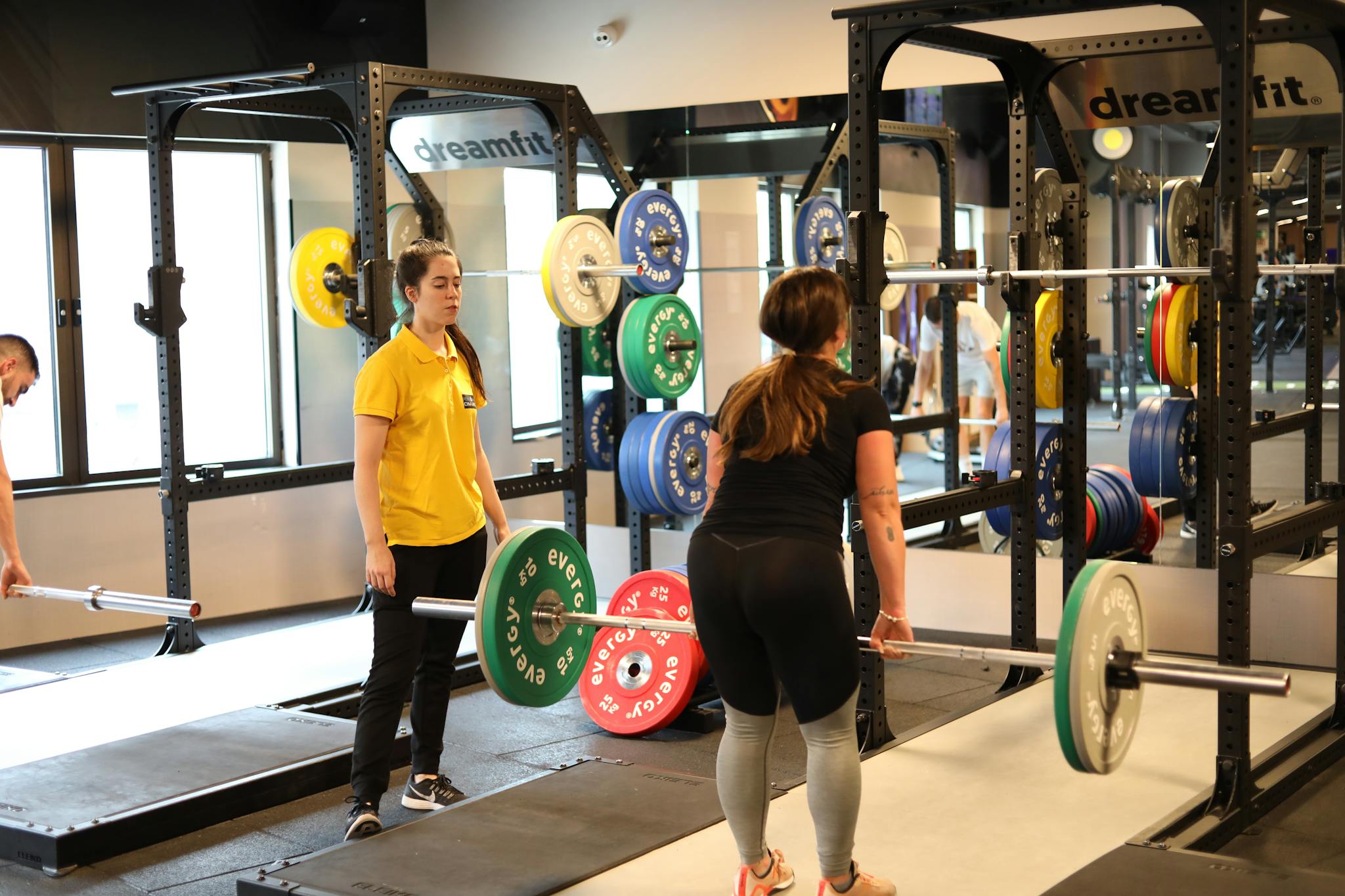 Services Two Women Weightlifting In A Modern Gym